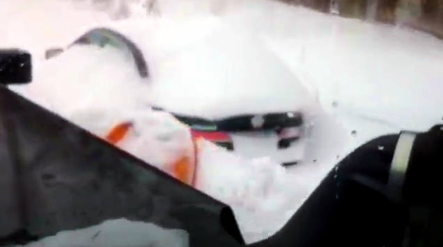 car being covered by snow plow