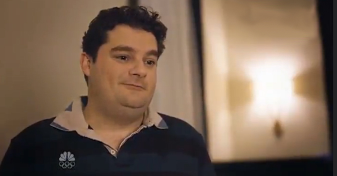 fat guy smiling in an apartment