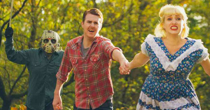 A couple running from a masked killer in a forest.