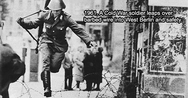 1961, A Cold War soldier leaps over barbed wire into West Berlin and safety.