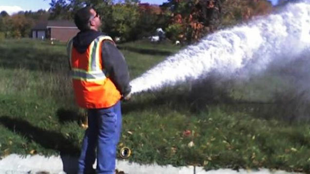 guy spraying hose like he's peeing