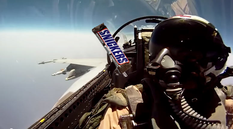 pilot passes snickers to co-pilot in fighter jet