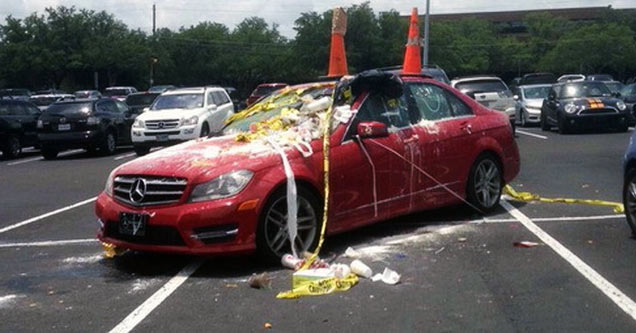 red car gets vandalized for parking in 4 spaces