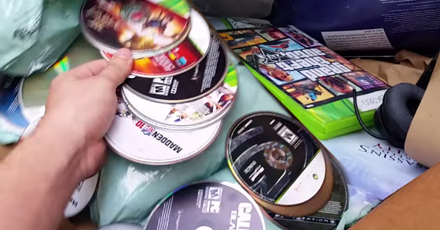 gamestop dumpster full of discarded merchandise