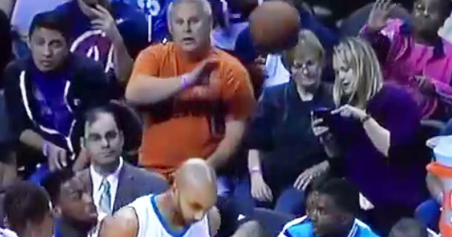 woman looking at phone about to get hit in the face with basketball