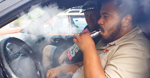 guy blowing smoke that dances in the car