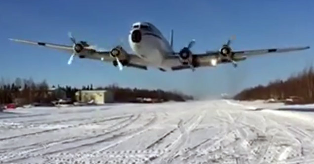 dc-6 airplane flies over head at low altitutde