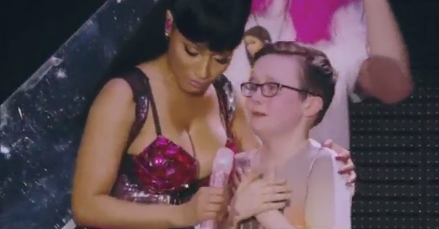 Little kid looks desperately excited to see Nicki Minaj.