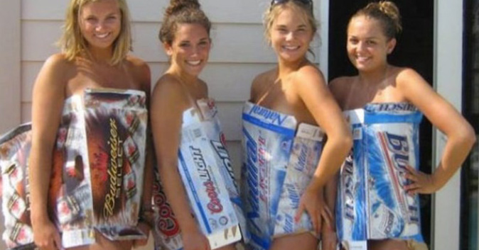 Girls wearing beer boxes as clothes.