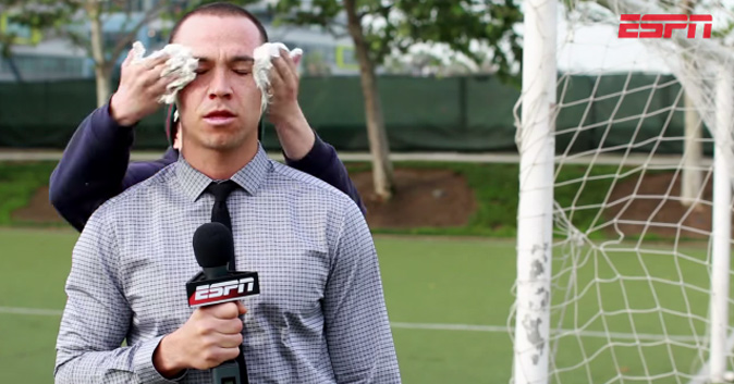 Reporter reports while cream-hands guy puts cream hands on reporter.