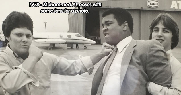 Muhammad Ali poses for a photo with his fans, 1978.