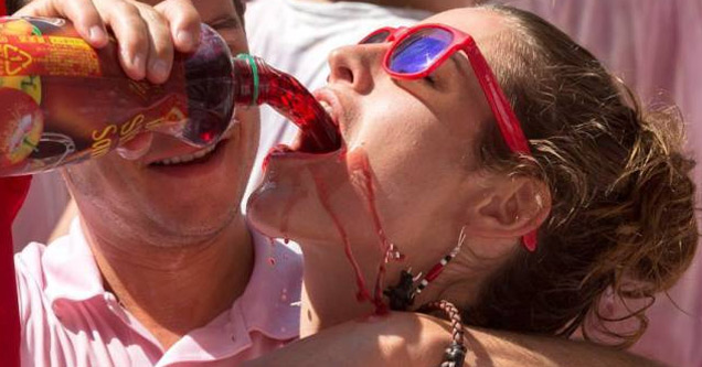 woman getting a drink poured down her mouth