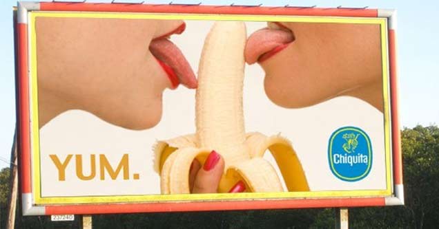 two tongues licking a banana on a billboard