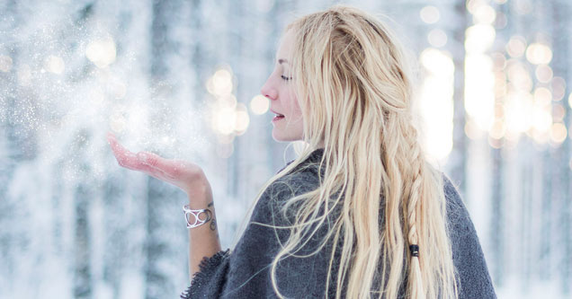 blonde woman in a snowy forest