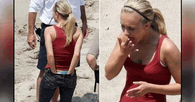 woman stuffing hands down pants then smelling them