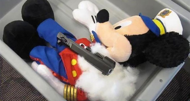 Okay, even more of a contradiction. This Mickey was packing heat in the form of a pistol.