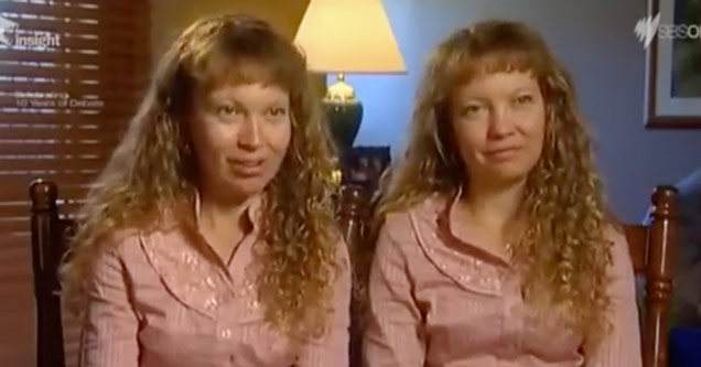 pair of twins in matching shirts and hairstyles