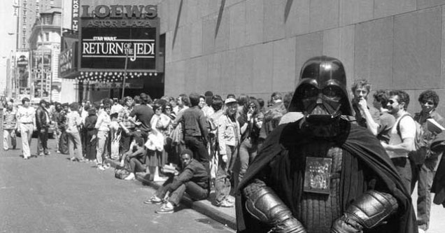 darth vader in front of line of movie goers