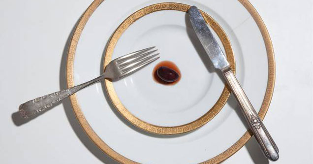 picture of a plate with a single olive on it