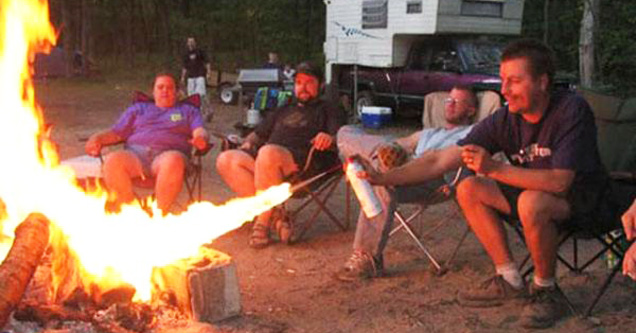 person torching a campfire