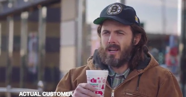 bearded casey affleck holding a dunkin donuts cup playing an actual customer