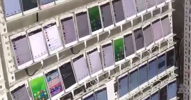 rows of cell phones in China used to fake social media likes