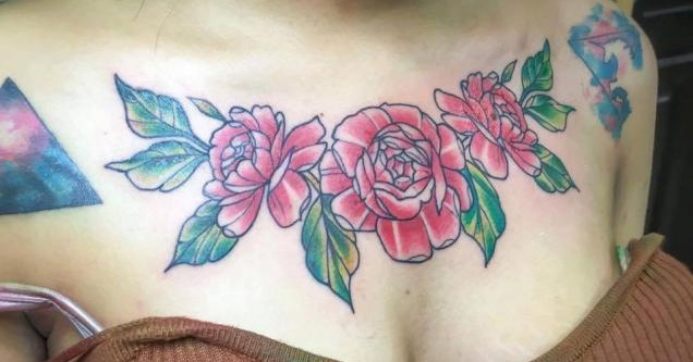 woman's chest tattoo of flowers