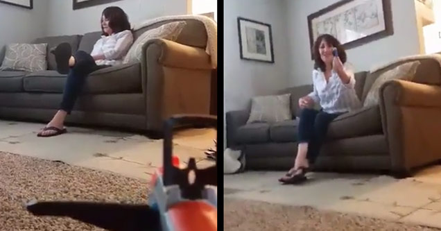 son with nerf gun aimed at mother, mother holding dart