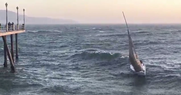 sailboat capsizes after getting hit by a huge wave