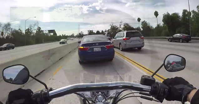 man riding motorcycle about to hit car in front of him