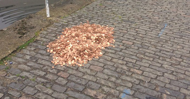 15000 assorted copper coins on sidewalk