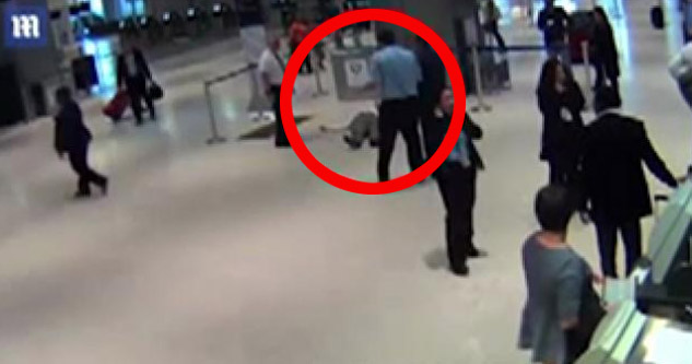 old man lying on the floor after being pushed by airport employee