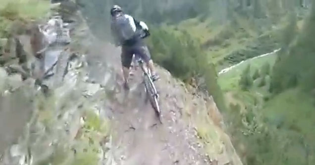 mountain biker on narrow cliff edge