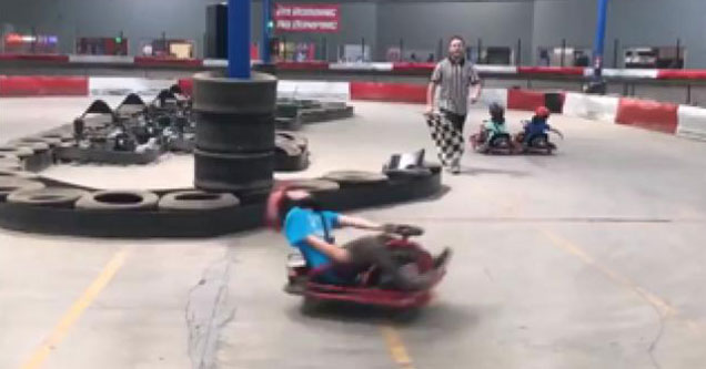 young kid on a go-cart spins out of control