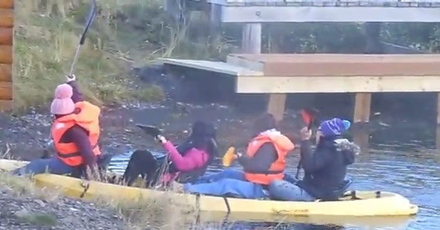 Chinese Tourists trying to use a kayak