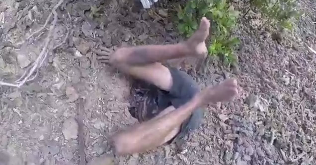 man climbs into hole after crab