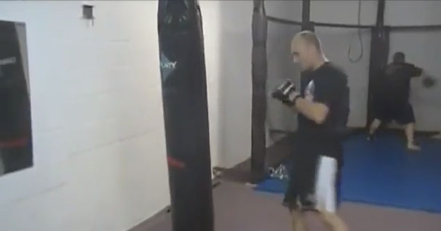 kickboxer practicing on a punching bag