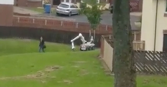 woman casually walks by demolition robot