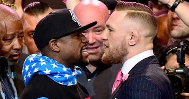 conor mcgregor and floyd mayweather standing off