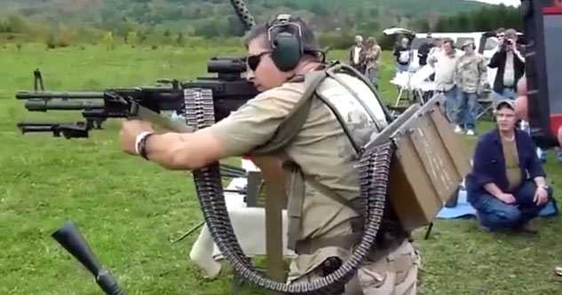 man carrying a back-pack mounted SAW