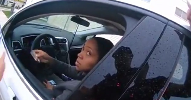 woman in white car being questioned by a cop