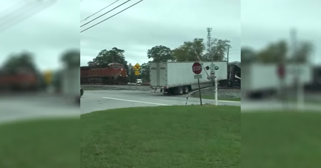 Train plows into semi truck stuck on the tracks