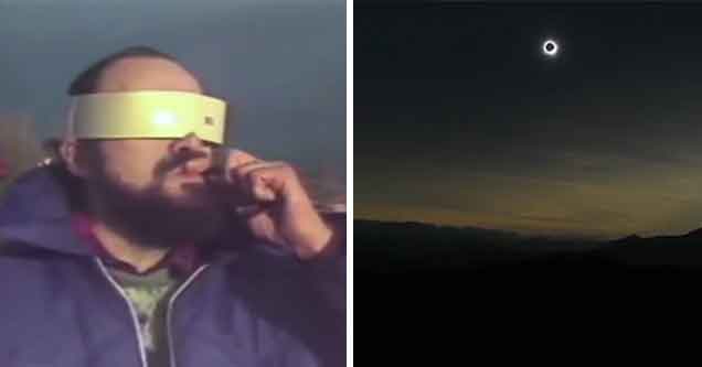 a guy watching a solar eclipse with solar eclipse glasses