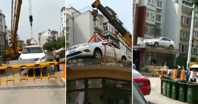 Crane moves illegally parked car in Azerbaijan