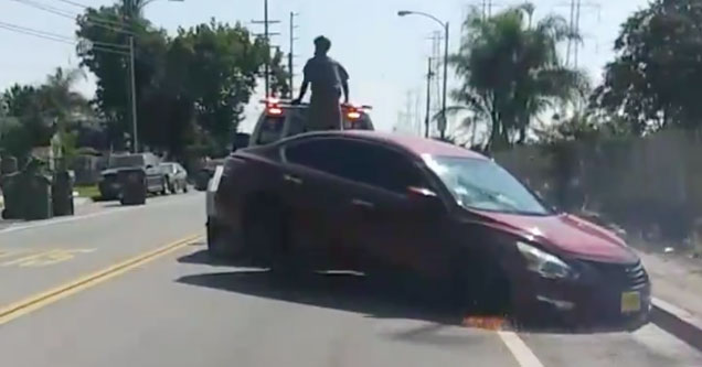 car being dragged behind a tow truck in compton