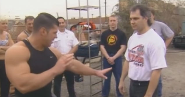 body builders take turns punching a karate master