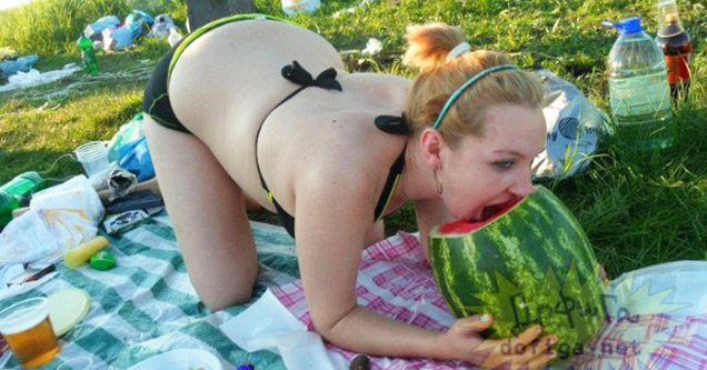 girl eating a watermelon on hands and knees