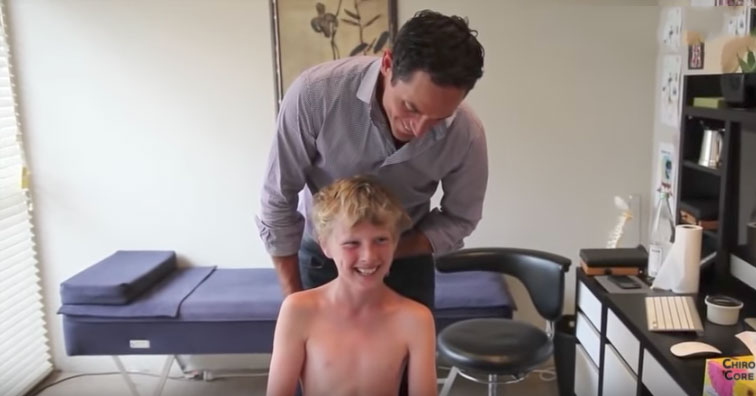 young boy smiles and laughs after his neck is put back in place