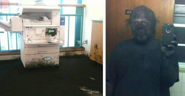 ink covered floor around a printer and man covered in black paint