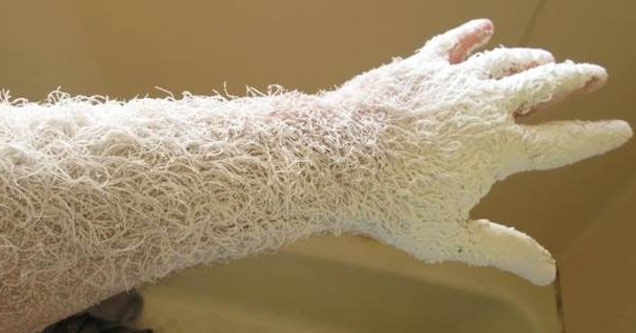 a mans arm covered in saw dust